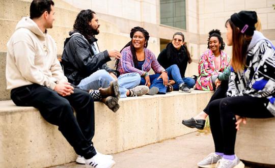 A group of UCSF Community members chatting together on campus.
