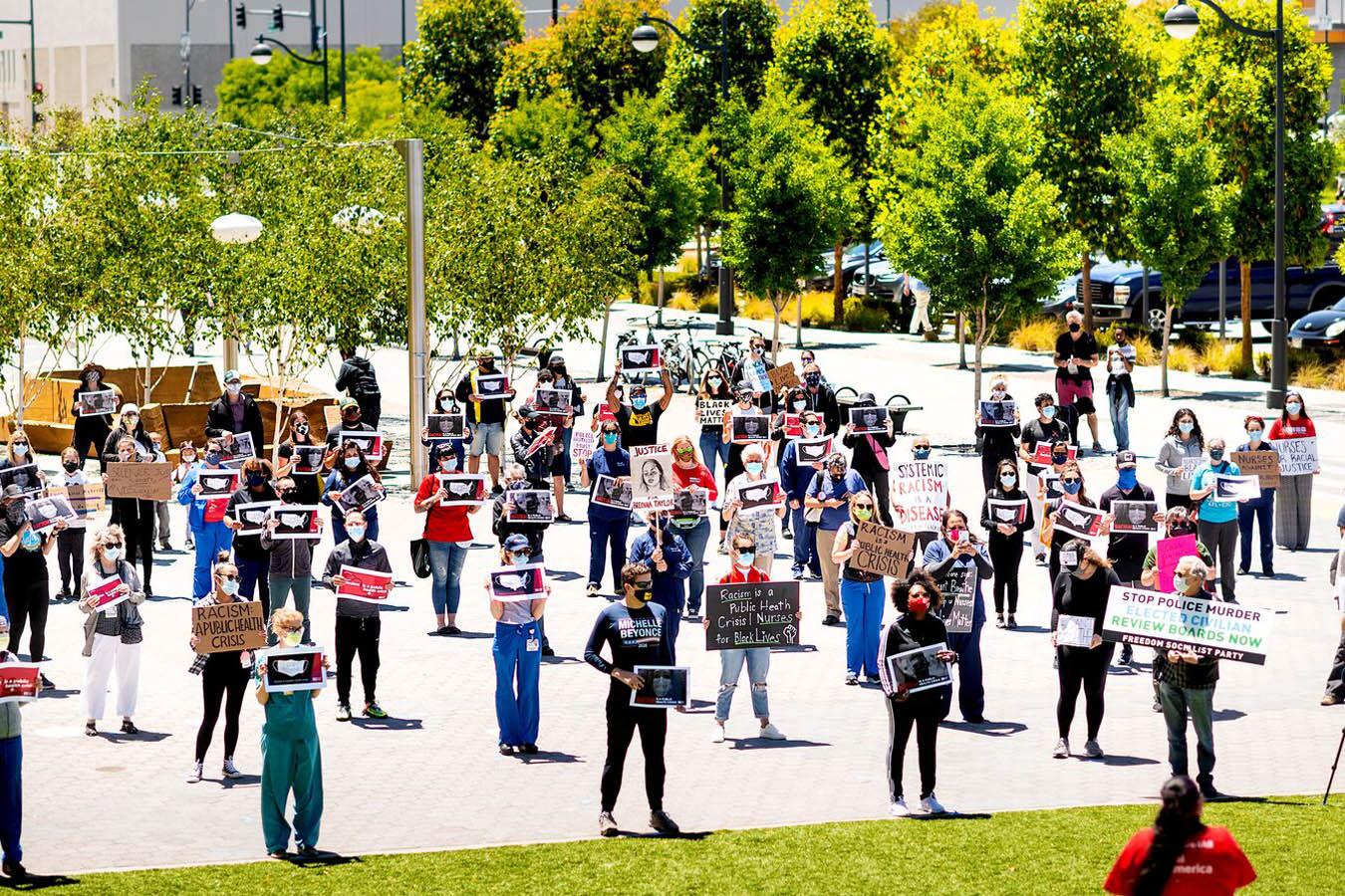 Dozens of UCSF nurses and fellow frontline workers gather for a Black Lives Matter protest organized by CNA at UCSF Medical Center at Mission Bay on Saturday, June 13, 2020, in San Francisco.