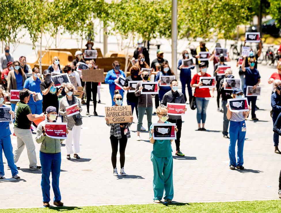 Dozens of UCSF nurses and fellow frontline workers gather for a Black Lives Matter protest organized by CNA at UCSF Medical Center at Mission Bay on Saturday, June 13, 2020, in San Francisco.