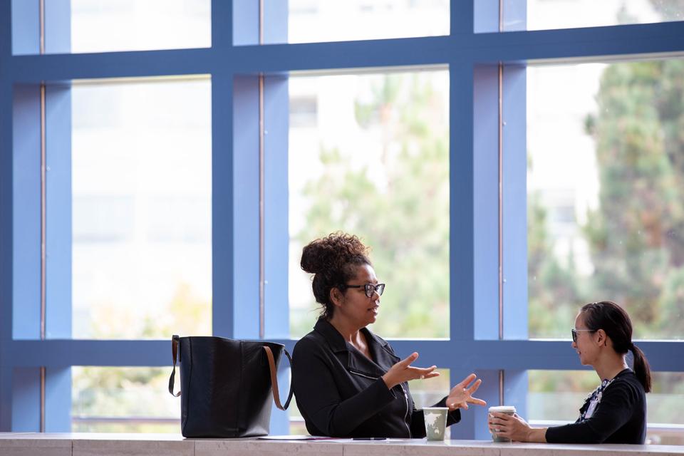 Meshell Johnson, MD and Michelle Yu, MD chat during a break at the 2018 Faculty Development Day conference, William J. Rutter Center at Mission Bay.