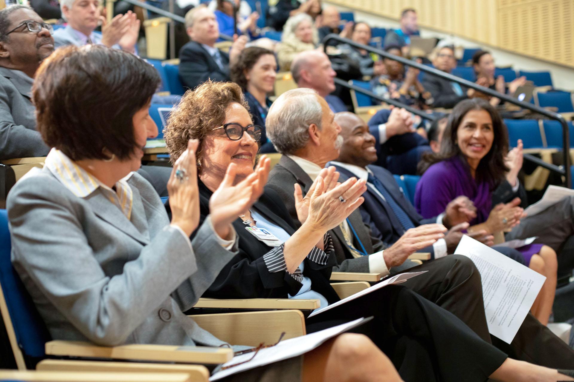 Seated attendees of the 2019 UCSF Diversity Leadership Forum applaud.