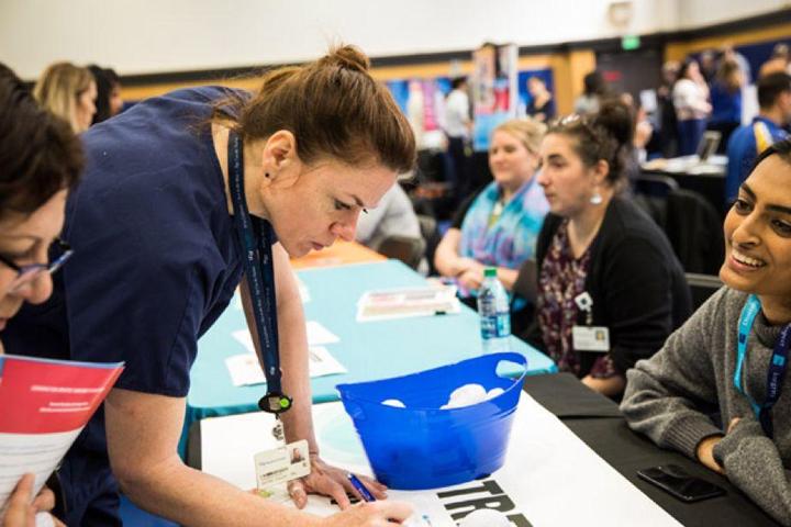 Attendees meet table presenters at the 2019 Staff Resource Day