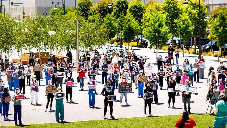 Dozens of UCSF nurses and fellow frontline workers gather for a Black Lives Matter protest organized by CNA at UCSF Medical Center at Mission Bay on Saturday, June 13, 2020, in San Francisco.