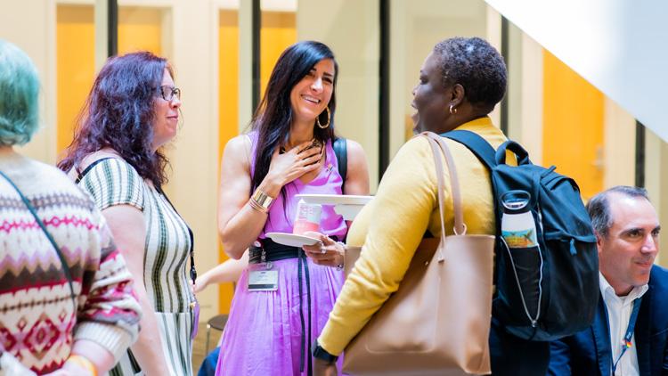 Attendees mingle and  chat at the 2023 Diversity and Inclusion Certificate Program graduation celeberation.