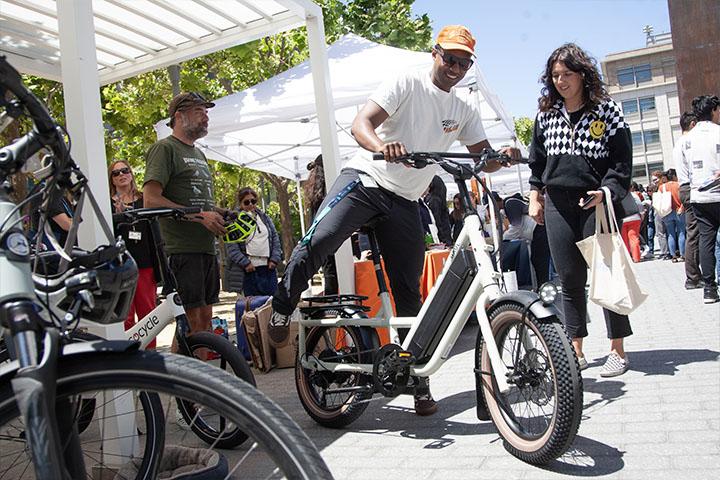 A Staff Resource Day participant is trying out an electric bike.