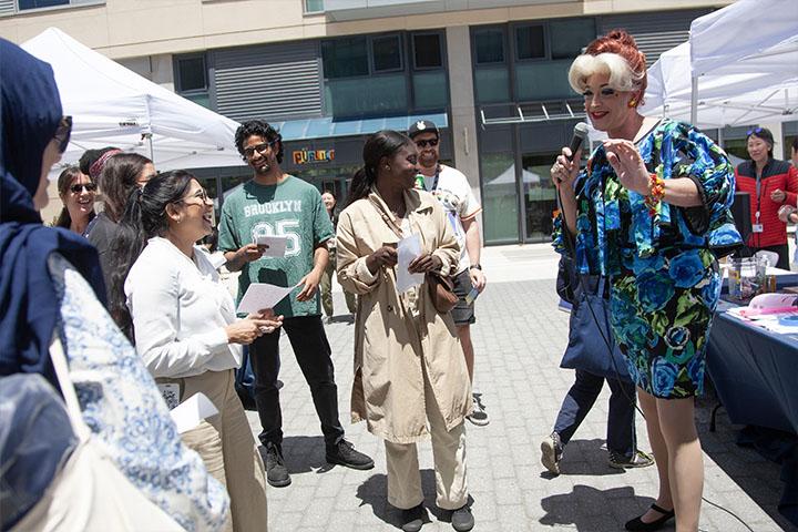 UCSF community members participating in a Bingo game to win prizes, hosted by a guest drag performer. 